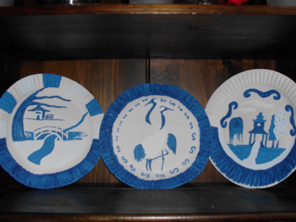 Willow landscape and wildlife painted on a plate in blue.