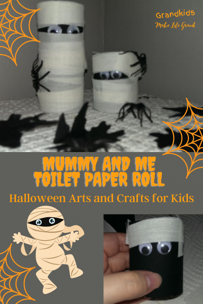Two mummies made out of toilet paper rolls with spiders around them and another toilet paper roll being wrapped to look like a mummy.