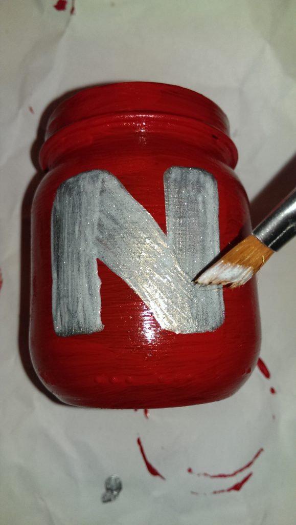 Jar painted red and added in silver the letter n