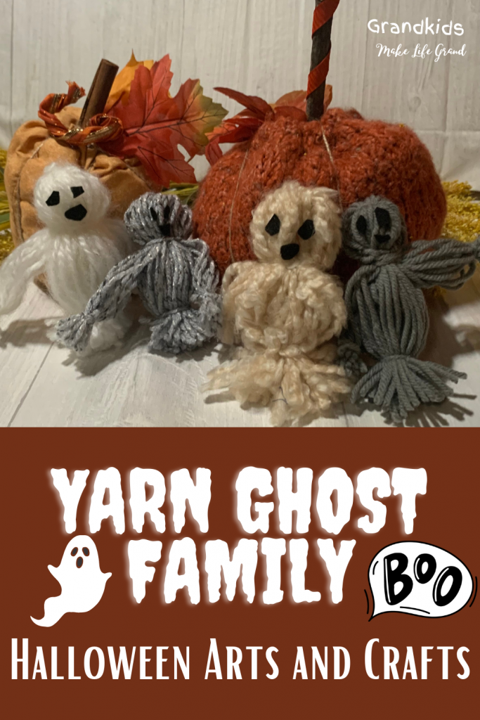 Different colored yarn made into a ghost family.