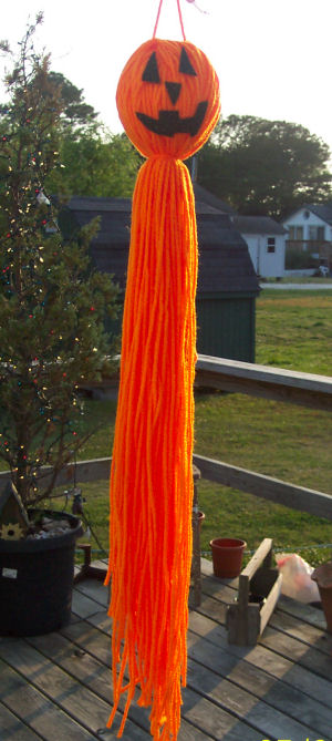 Jack-o-latern made from yarn that hangs as a windsock