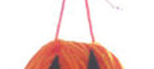 String tied to top of jack-o-lantern made out of yarn.