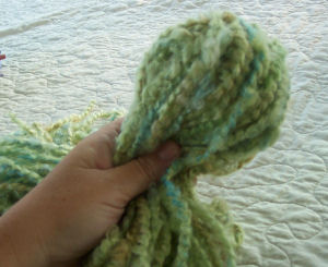 Green yarn wrapped around styrofoam ball to make octopus head