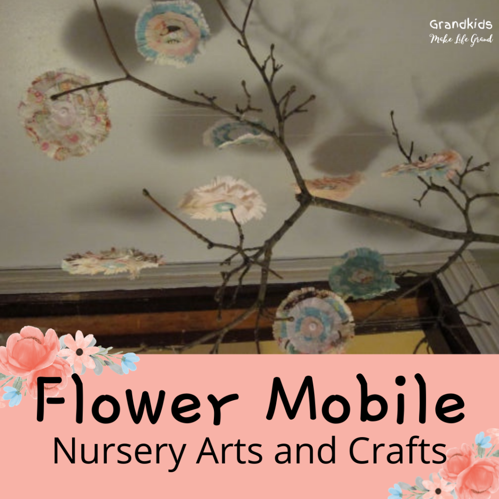 Flowers made out of paper and sticks added to make a mobile
