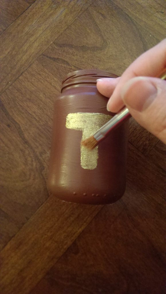 Painting a t on the a jar