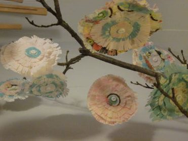 Flowers made out of paper and tied onto sticks
