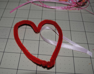 Making a heart out of red pipe cleaner