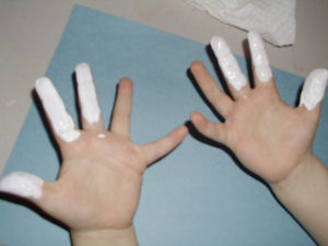 white paint put onto child fingers and stamped to make a bunny.
