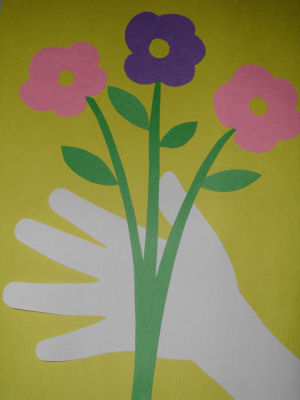 paper hand holding paper flowers