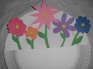 paper plate turned into a basket with paper flowers inside