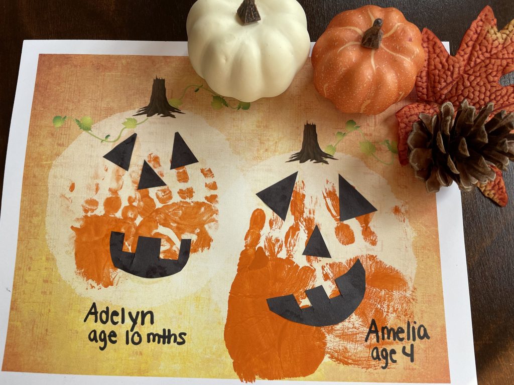 handprints made into a rustic pumpkin art